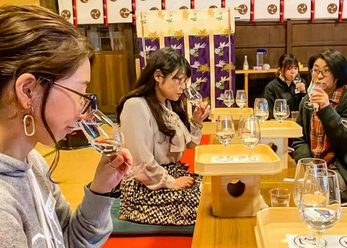 Guests at a Niigata sake tasting smelling the unique bouquet of Niigata-made sake.